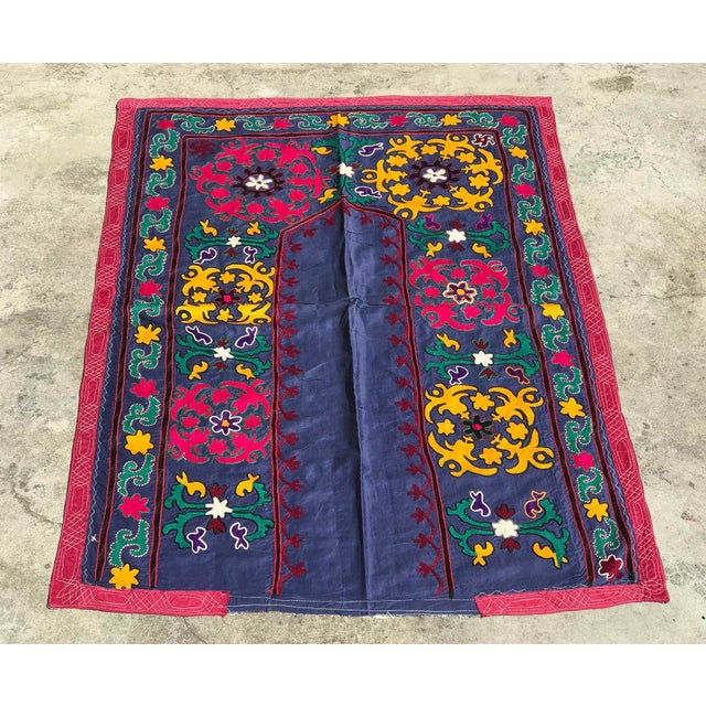 A colorful blue and pink suzani fabric in door design makes a wonderful handmade bedspread, table cover, or wall hanging....