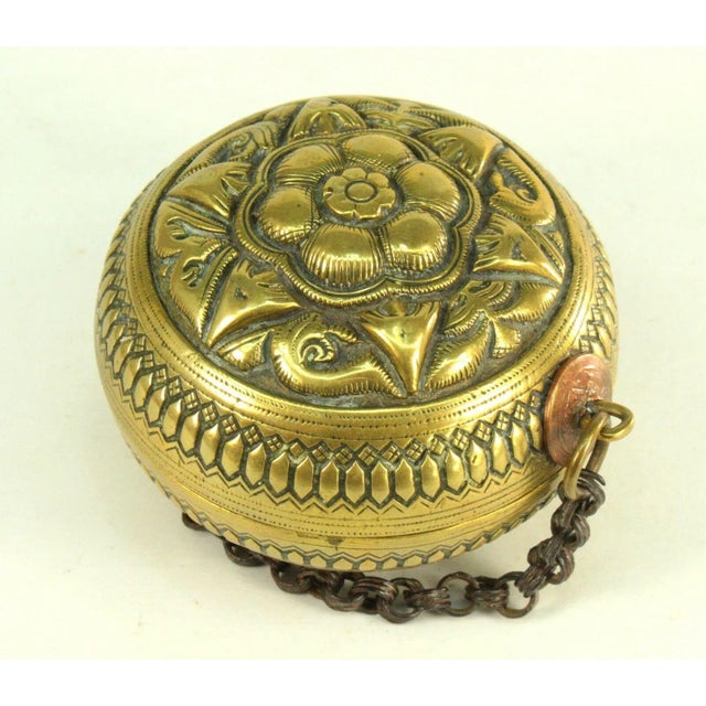 A superb antique betel nut and lime container, made of thick cast and hand chased bronze or brass Two halves fit together,...
