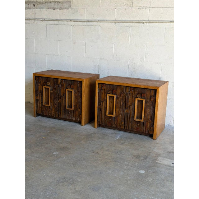This pair of architectural end tables features a bold textured facade composed of multi-dimensional geometric wood blocks....