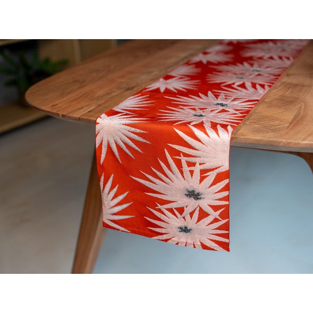 Hi no de. The rising sun. The starburst at first light — woven here in vermilion silk with silver radiance, modern in...