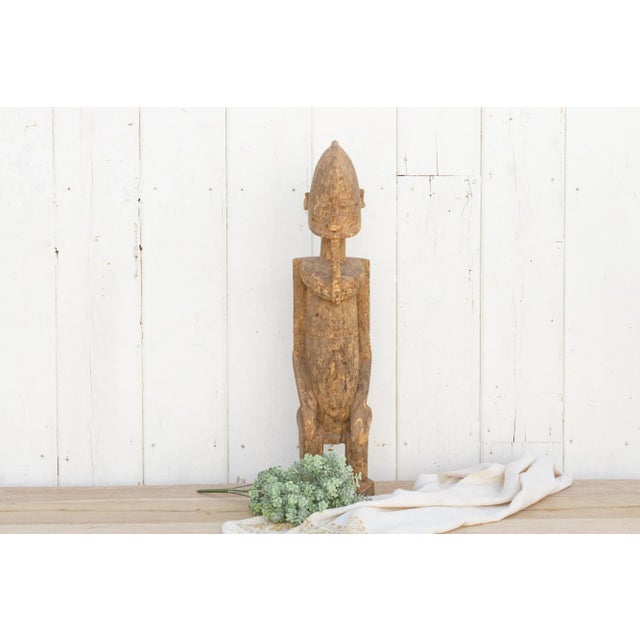 Showing a tribe chief seated on throne, this mesmerizing African statue is carved from a single piece of wood and its...