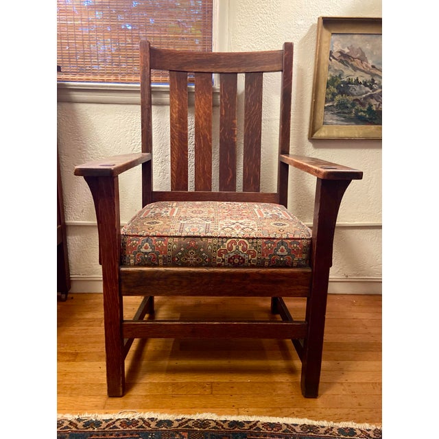 Very nice antique oak arm chair with original finish and newer seat upholstery. Chair is sturdy and comfortable.