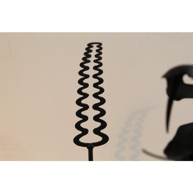 Black snake in a modernist form. Great patio decor or a surprise for your entryway.
