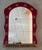 Rare Spanish Colonial wall mirror with an angular frame upholstered in antique red velvet and composed of naturally...