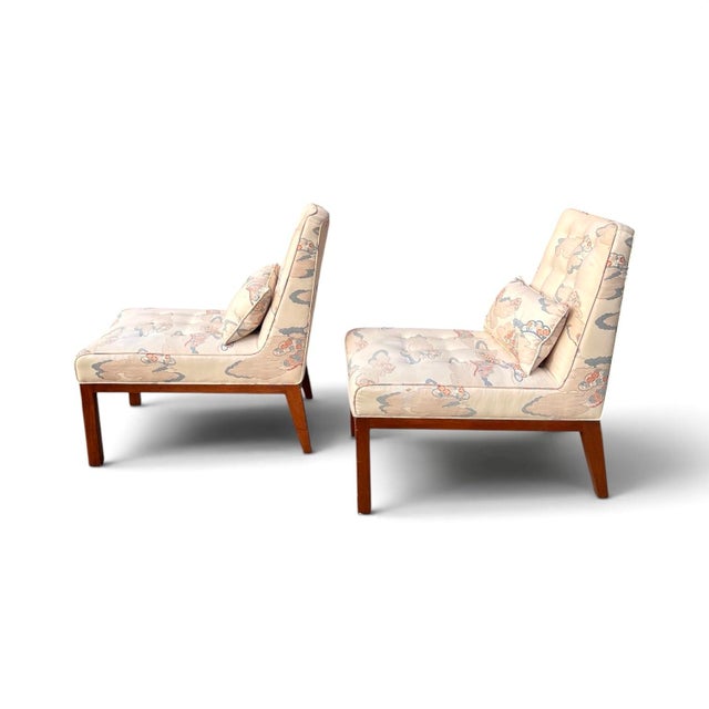A pair of slipper chairs with bolster pillows by Edward Wormley for Dunbar.