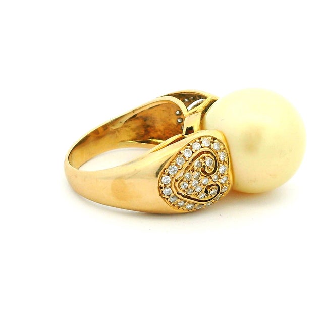 Elegant and eye-catching, this statement ring features a luminous golden South Sea pearl set in polished 14K yellow gold...