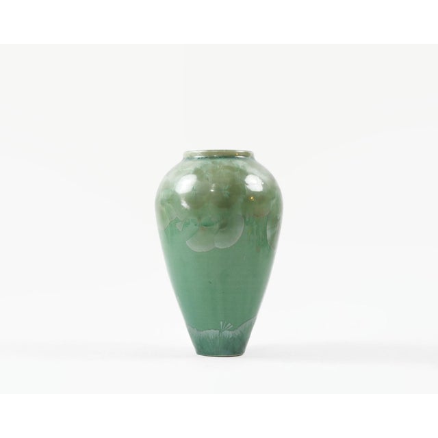 Small porcelain vase with crystalline glaze in celadon green. Some of the crystal patterns resemble Ginko leaves. Made by...