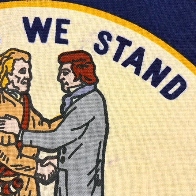 This vintage Kentucky flag is made from a cotton cloth, with printed emblem sewn around its edge and visible on both...