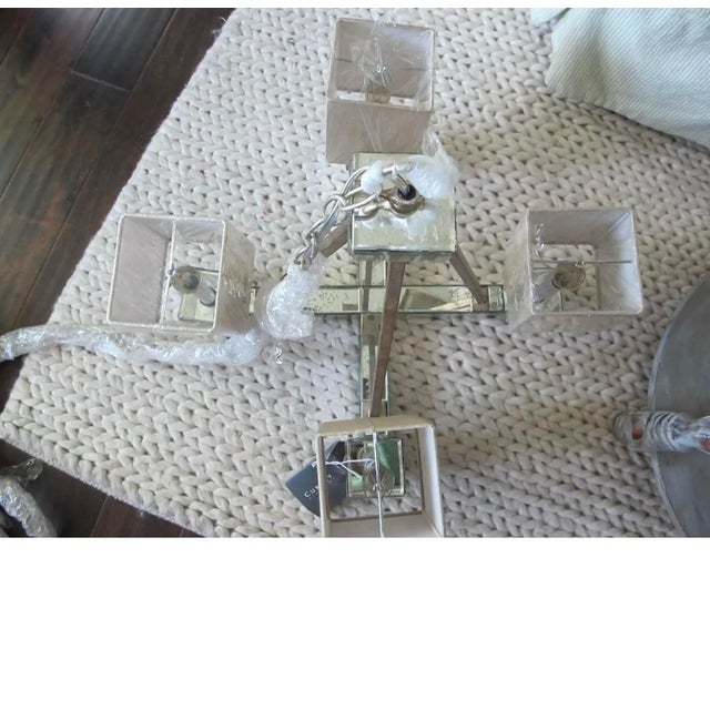 Currey & Company Raj mirror bronzite 4 light chandelier. 4 lite with beige linen shades. Chain is 65” long. Total height...
