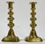 Decorative pair of antique English brass push-up style candlesticks. Feature detailed shaft and squared bases. A stunning...