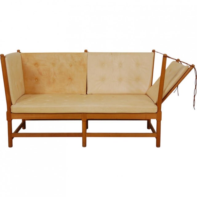 Børge Mogensen spoke-back sofa from the 1980s with a frame of beech and cushions upholstered in natural leather. The sofa...