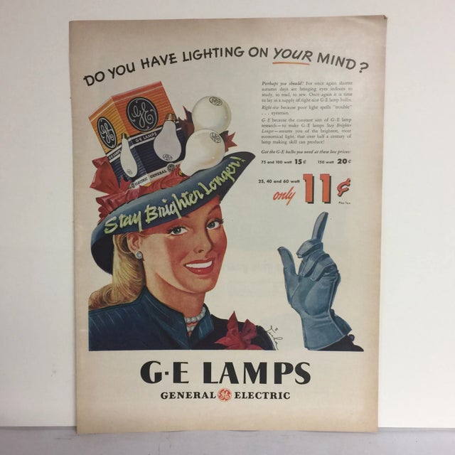 Marvelous ad from the 1940s showing a woman wearing a hat of GE light bulbs, says "Stay brighter longer!" Marvelous color...