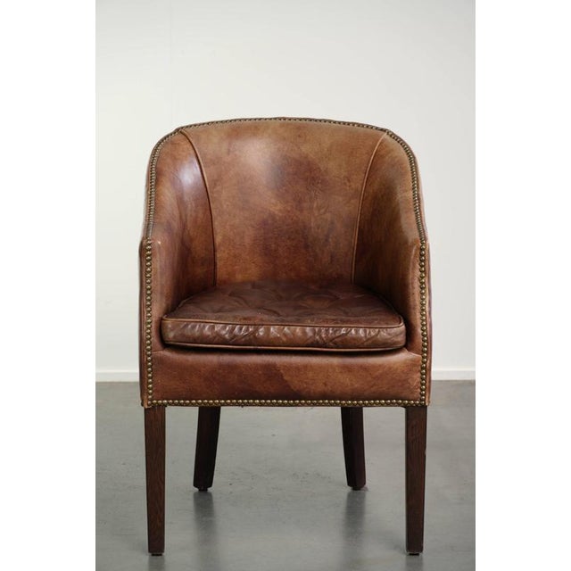 his comfortable occasional/desk chair in characterful cognac-colored cowhide leather with a beautiful patina is finished...