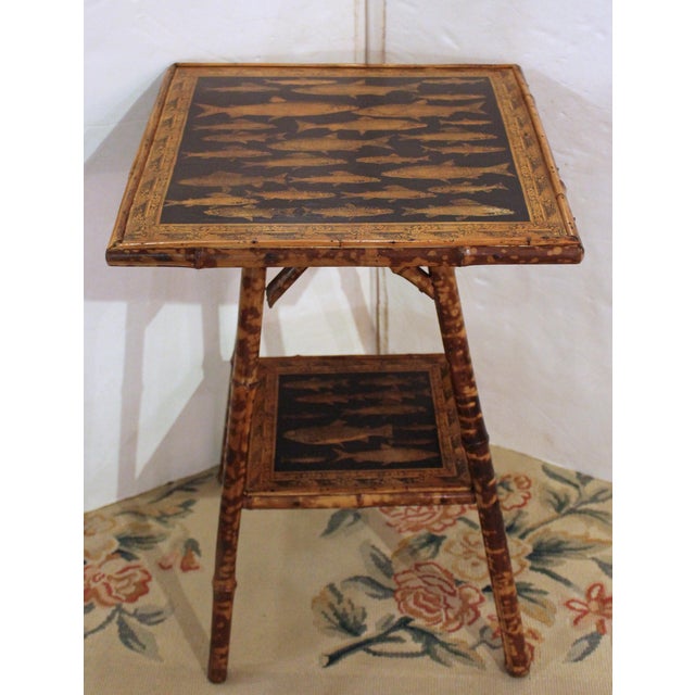 Late 19th century large square bamboo 2-tier side table, English. The surfaces now artisan decoupaged with fish....