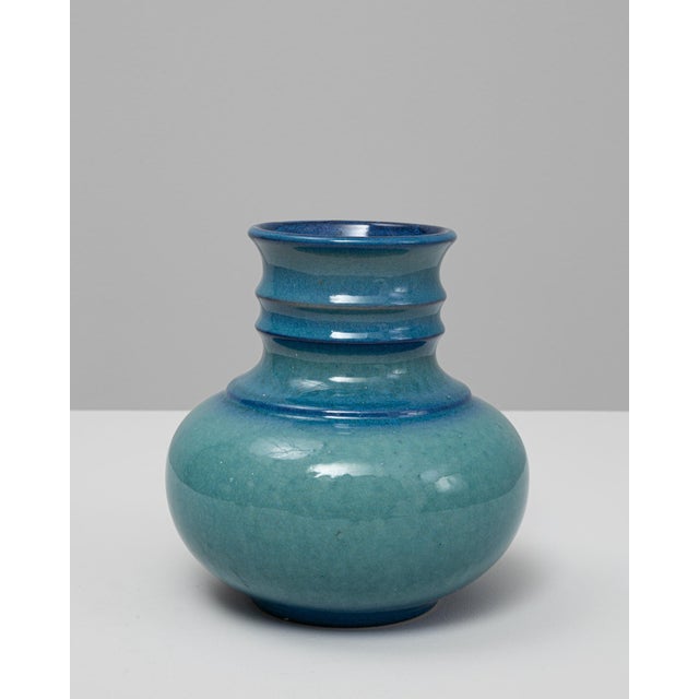 This 20th Century German turquoise ceramic vase features a soft, rounded silhouette paired with a subtly sculpted neck,...
