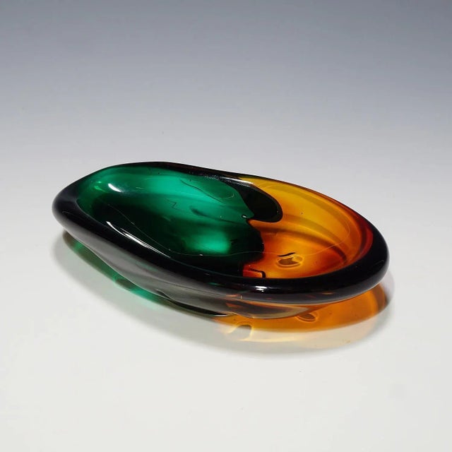 A vintage class bowl in 1950 style with thick overlapping green and orange glass and clear glass overlay. Signed on the...