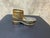 A miniature lace-up mountain boot with a lugged sole, fitted with a hinged lid over the toe that opens onto a shallow...