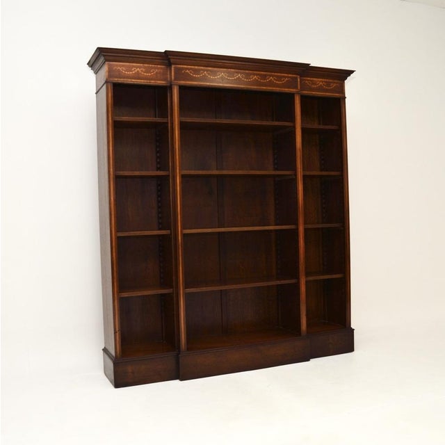 A beautiful and impressive antique Sheraton style open bookcase. This was made in England, it dates from around the...