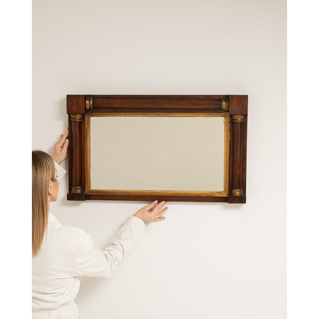 This piece presents as a mirror, distinguished by dark walnut frame with gilt inner banding. The piece dates to 19th...