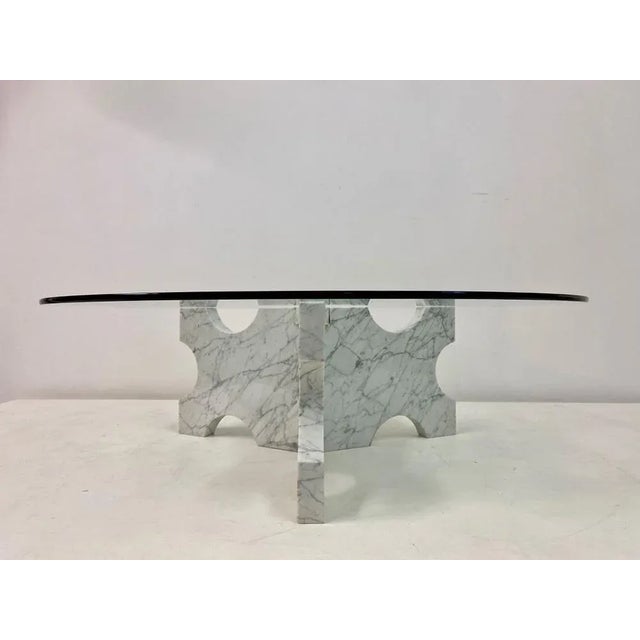 Carrara marble coffee table. Shaped base, glass top. Italy, 1970s.