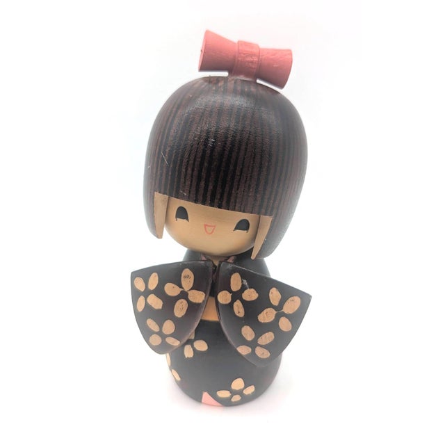 Offered is a diminutive vintage wood Kokeshi doll handcrafted and painted in Japan circa. 1970s. This particular Kokeshi...