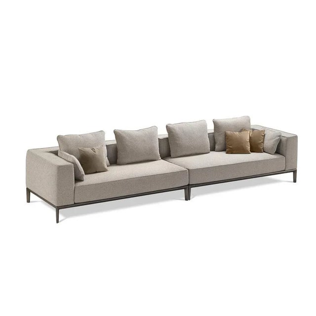 This elegant sofa upholstered with gray fabric represents the perfect piece to blend in sober, modern interiors or...