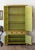 A fantastic Chinese distressed citron yellow lacquered cabinet. Supported on four squared legs with lower case having two...