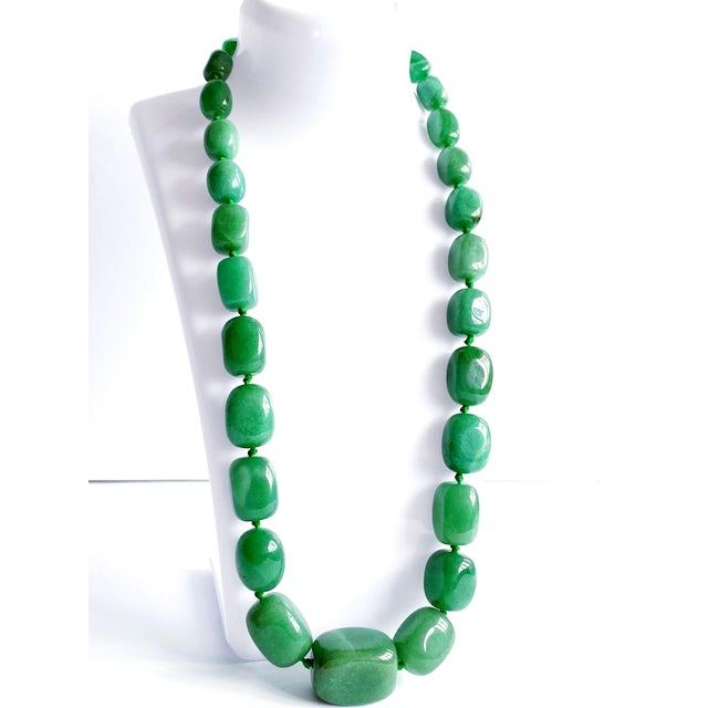 This striking, oversized green aventurine necklace is a sophisticated statement piece, handcrafted with large, richly...