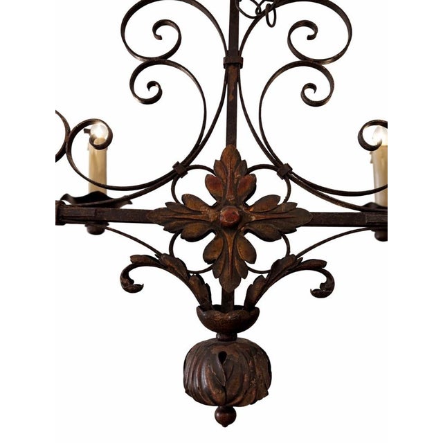 A beautifully scaled vintage French wrought iron chandelier dating to the 1950s, featuring six candle-style lights,...