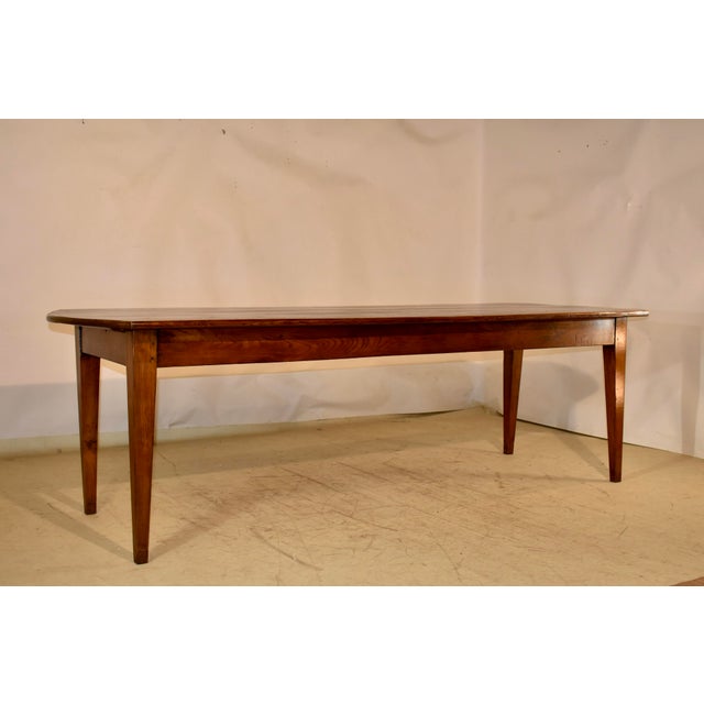 Early 19th century long farm table from France made from chestnut. The table has a wonderfully grained top with lovely...