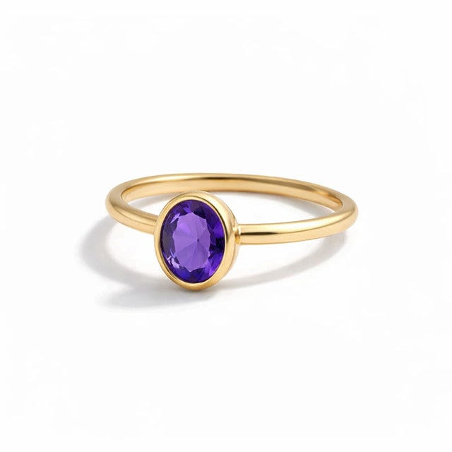 This ring is a beautiful example of minimalist elegance, combining a vibrant splash of color with a clean, modern design....