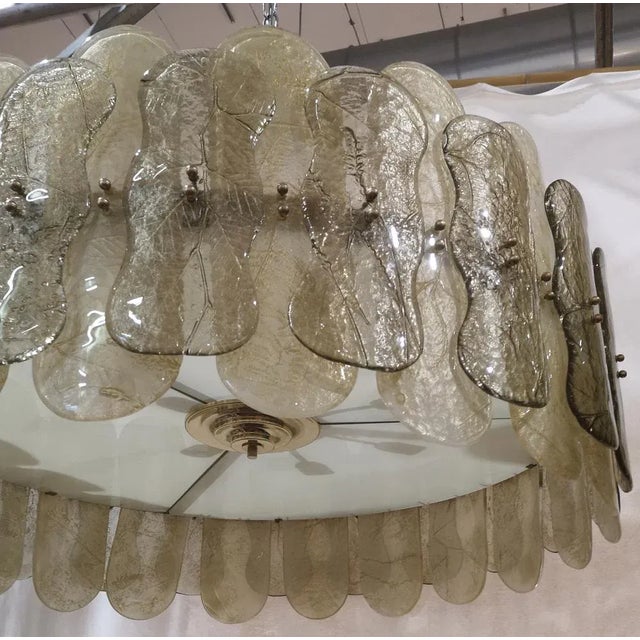 Fantastic round chandelier in Murano glass and polished brass. Note the shape of the amber and smoky Murano glass plates,...