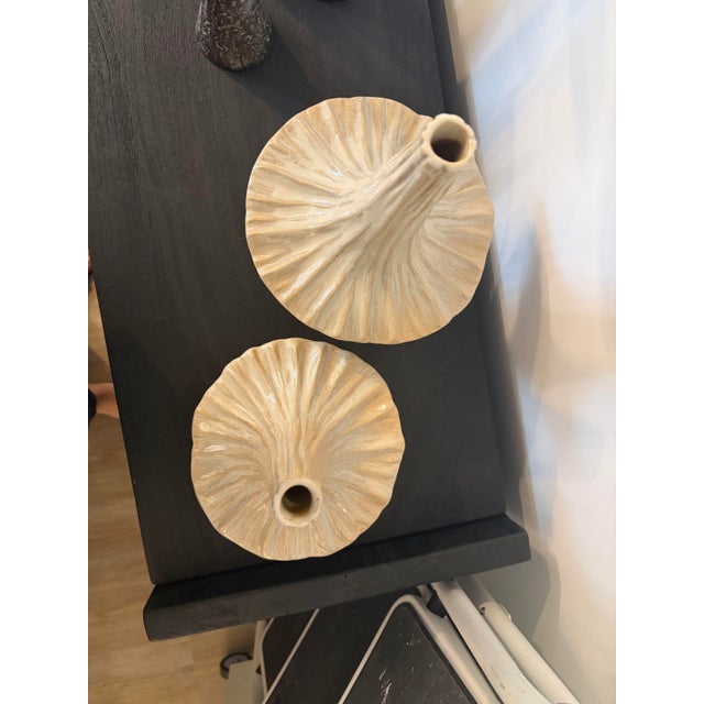 Crafted from slip-molded ceramic, the Gamma Bottles boast an intriguing beige glaze that adds an artistic touch to any space.