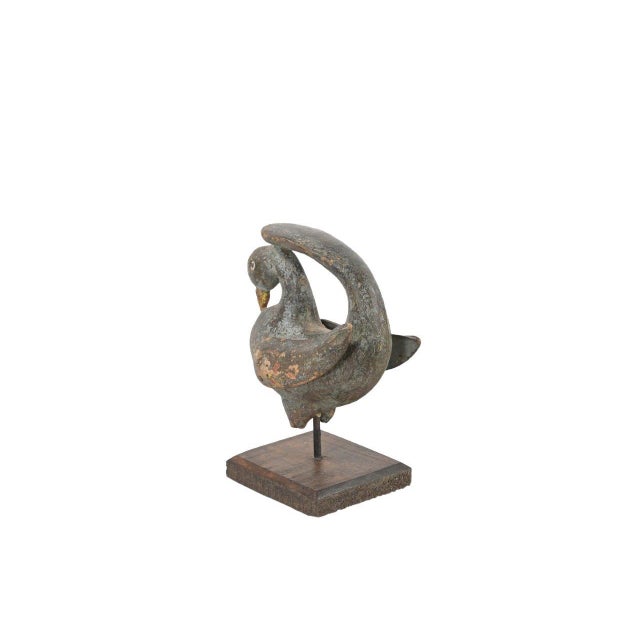 This Antique Indian Carved Teakwood Corbel on Stand is hand-carved from solid teakwood, depicting a stylized bird form...