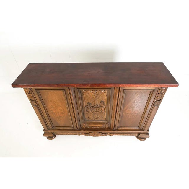 A Baroque style carved sideboard / credenza with generous bun feet. The cabinet has a nicely carved front panel depicting...