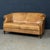 Exhibiting a superb patina and rich, mellow tones, this exceptional sofa was hand-upholstered in sheepskin leather by...