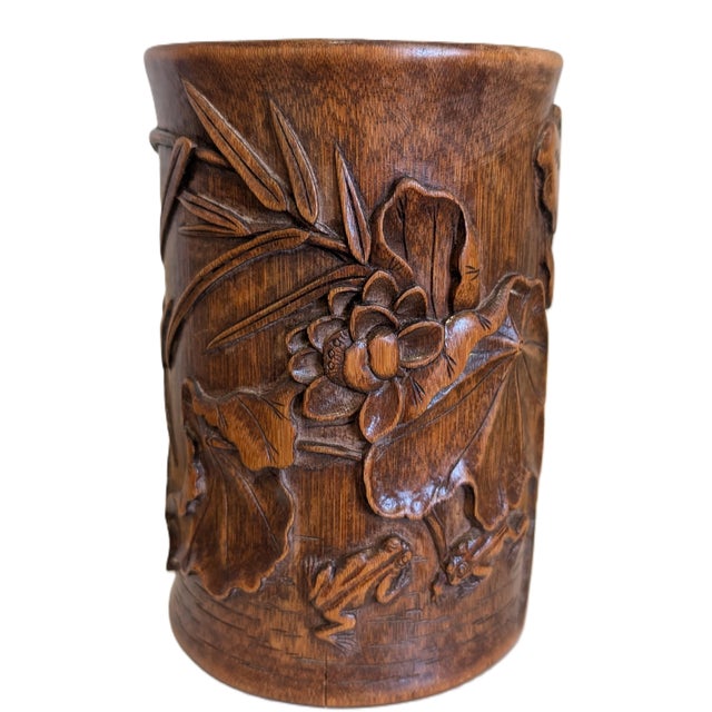 A scene of a garden pond with lotus flowers, a frog, and a garden stone. Patina can be seen on the surface and the base.