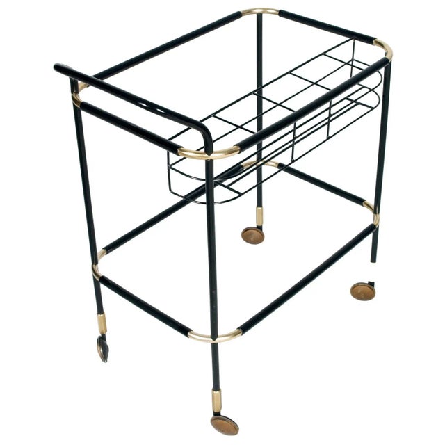 This is an elegant and rare 1960s trolley bar cart from MB Italia in gilt brass that is encapsulated with black resin. It...