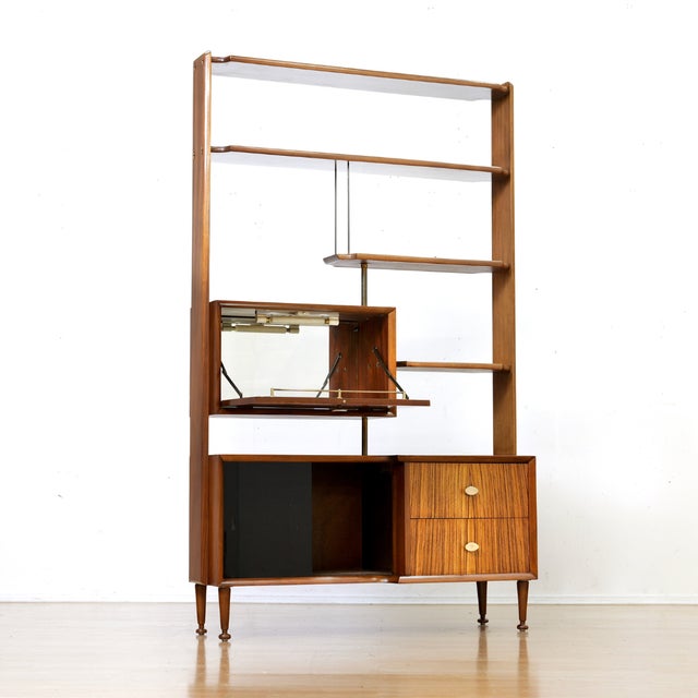 This vintage room divider is a fine example of the early 1960s British design. Made from tola, the cabinet is a...