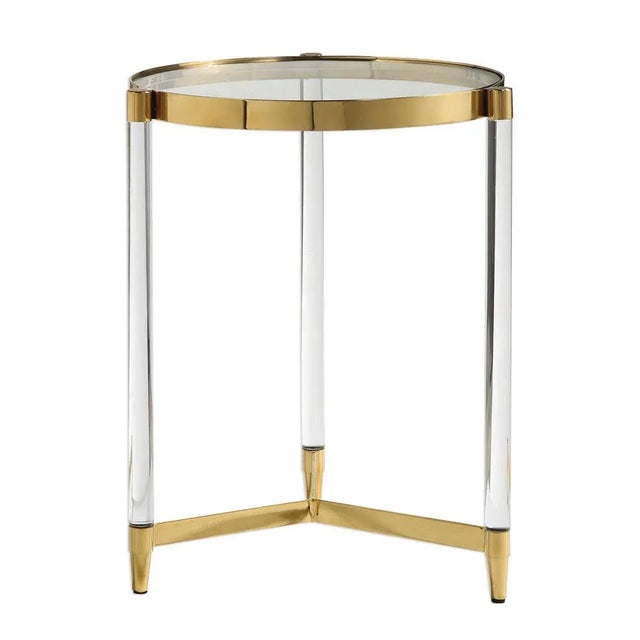 A true glam accent, featuring a gold plated stainless steel frame with clear glass, acrylic legs and tapered metal feet....