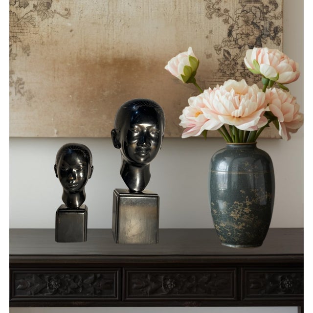 Two rare 1950s bronze busts of a young Vietnamese woman by modernist artist Nguyen Thanh Le (1919–2006). Each sculpture...