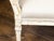 An Italian painted wood sofa from the 19th century, with two slanted sides, tapered carved legs and distressed patina....