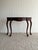 This vintage mahogany demi-lune entryway table features a graceful serpentine front, long cabriole legs, and carved shell...