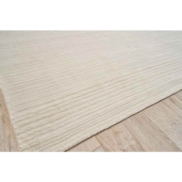 The Rossini rug was designed to ground any room with its lush softness, rich dimensional texture and striated design. Made...