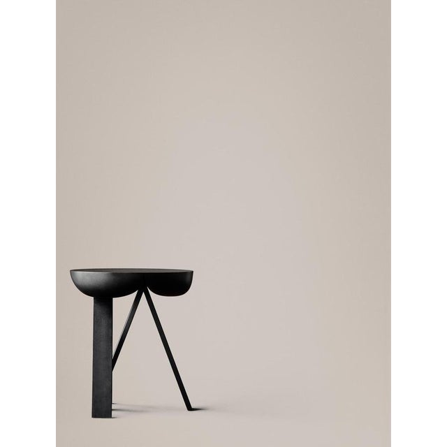 Side table designed by PlueerSmitt in 2014. Striking. Wooden side table consisting of two stripped-down trestles and a...