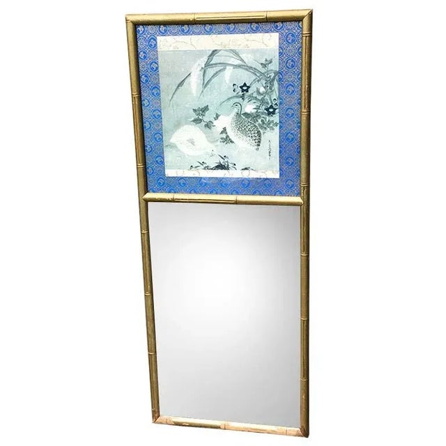 Beautiful tall chinoiserie mirror. The frame is faux bamboo with gilt wood. The top of the mirror features a chinoiserie...
