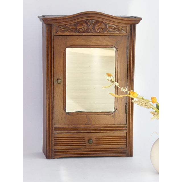 A stunning Art Deco wooden oak cabinet with rectangular beveled mirror. The small apothecary is made in France in the...