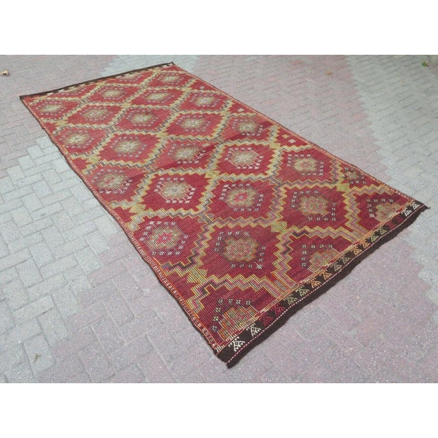 This beautiful, traditional vintage, flatweaved Turkish kilim is approximately 60 years old. It is handmade of very fine...
