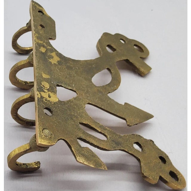 This brass nautical rack will corral keys, pet leashes scarves or any miscellaneous items you need to keep track of. With...