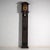 This antique longcase clock rises on a solid pine case painted in dark green, with two painted panels of floral sprays...